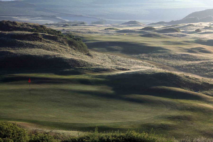 St Enodoc the green on the par 3 17th hole foreground with the green on the par 4 1st hole behind 1 v2