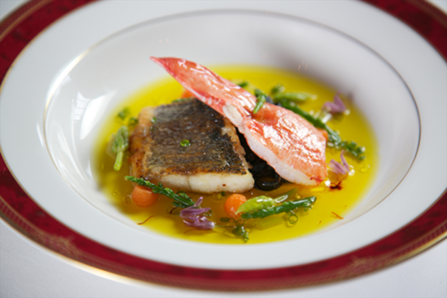 Food Sea Bass with Tomato Saffron Essence and Butter Poached Lobster Claw